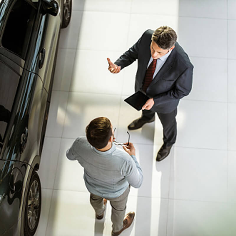 Auto salesman speaking with a potential customer