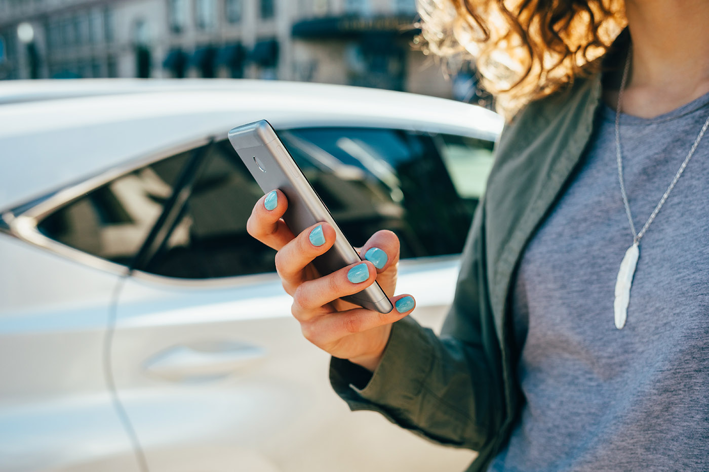 Young woman using smart phone standing on street